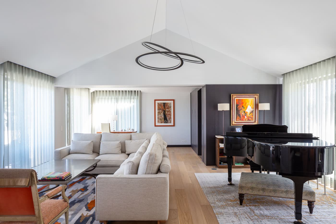 Living room with a grand piano after a full renovation in Cascais
